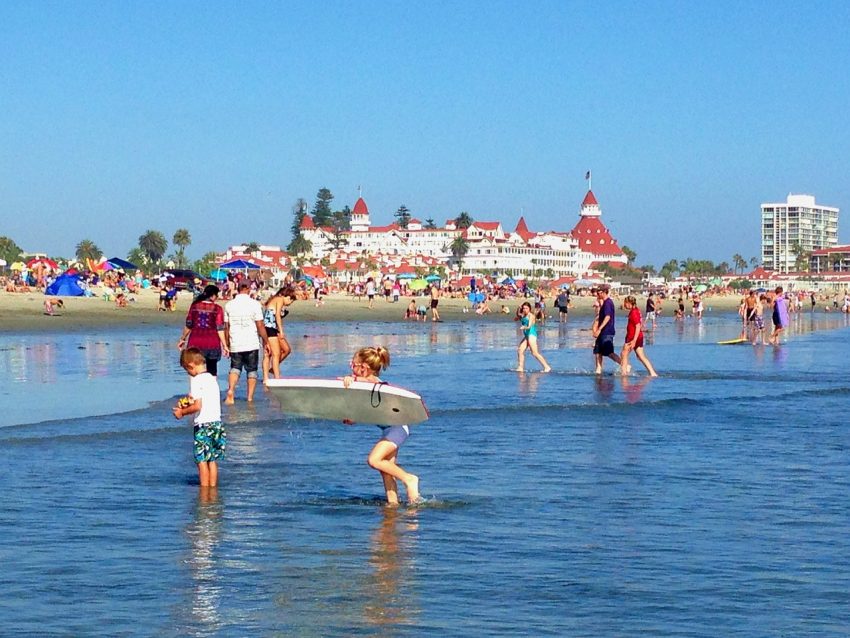Coronado Central Beach runs along Ocean Boulevard with a backdrop of fine homes and mansions and the Hotel del Coronado at the southern end.