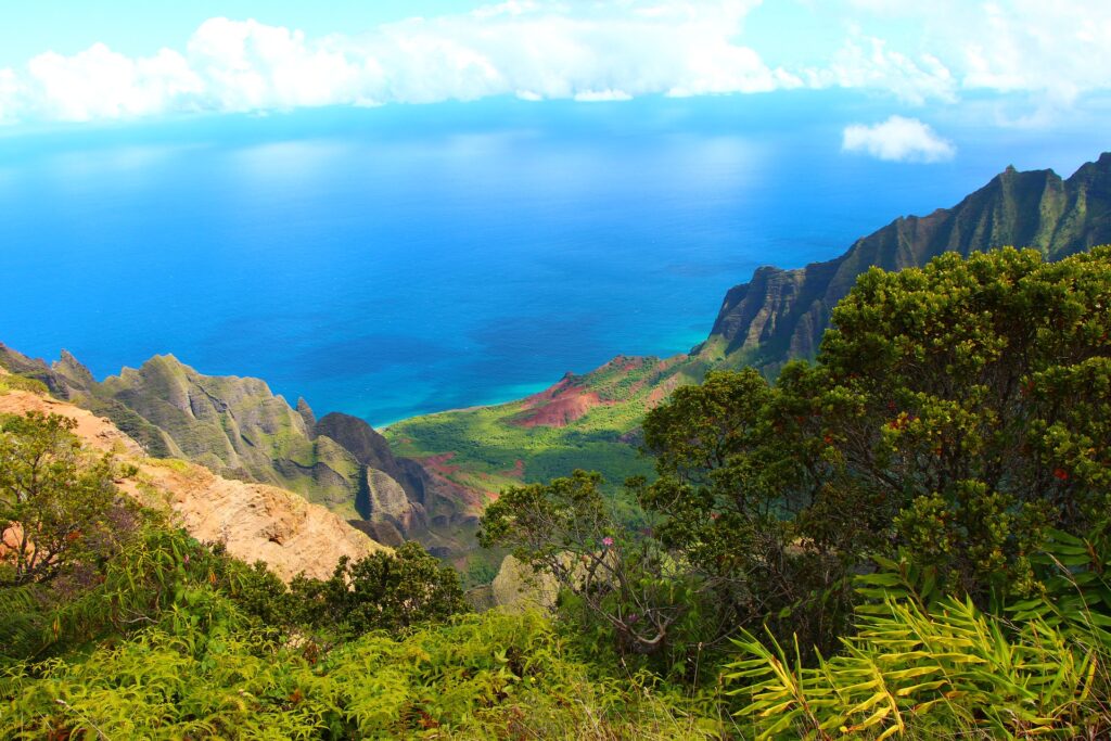 Visit Kauai, the Hawaiian island know as the Garden Isle, draped in emerald valleys, sharp mountain spires and jagged cliffs.